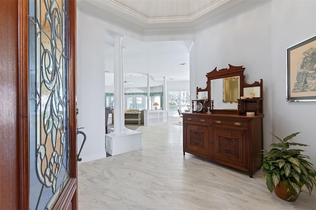 entryway featuring decorative columns, marble finish floor, and crown molding
