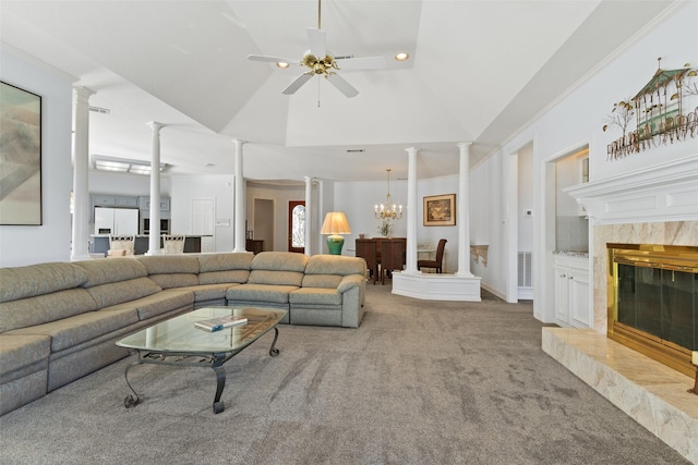 living room featuring ceiling fan with notable chandelier, ornate columns, carpet floors, a premium fireplace, and recessed lighting