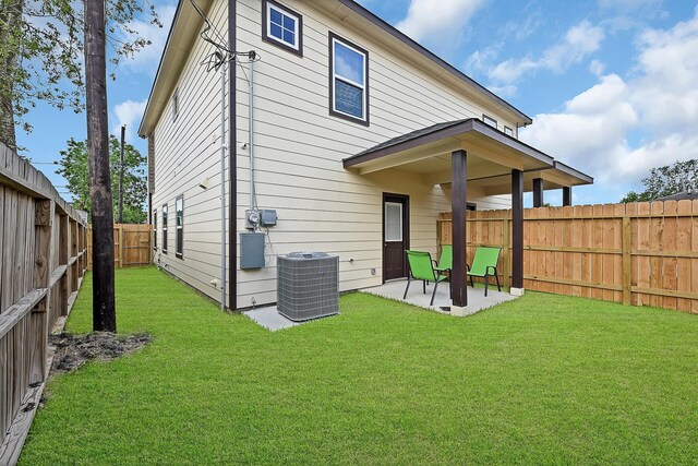 4903 Mallow St Unit Ab, Houston, TX 77033 - rear view of house with a patio, a fenced backyard, a yard, and central AC unit