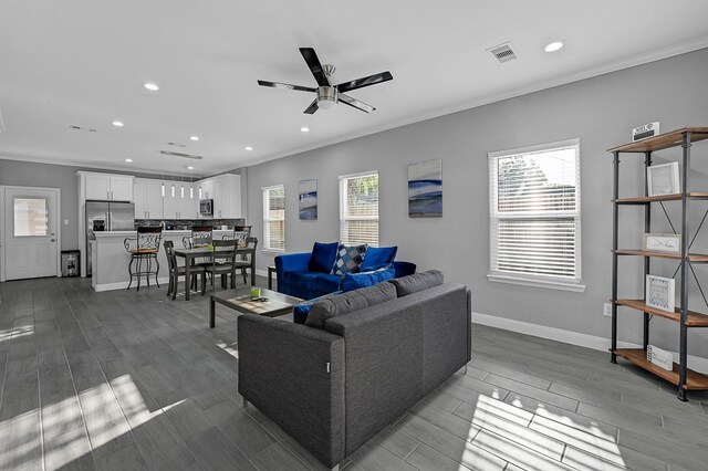 4903 Mallow St Unit Ab, Houston, TX 77033 - living room with ceiling fan, baseboards, ornamental molding, and recessed lighting