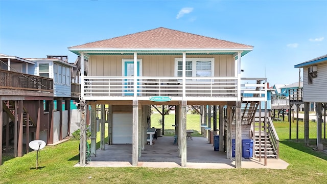 214 Sand Dune Ct, Surfside Beach, TX 77541 - back of house with a lawn, stairway, a carport, and a shingled roof