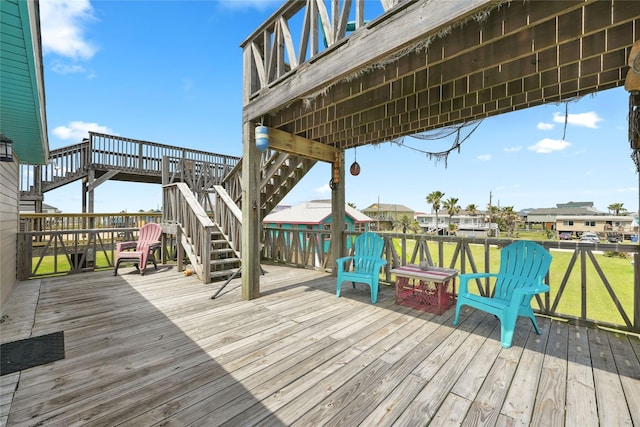 214 Sand Dune Ct, Surfside Beach, TX 77541 - wooden terrace featuring a lawn and stairway