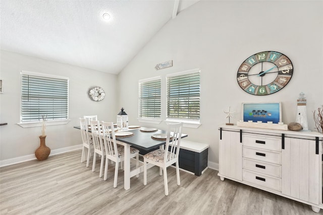 214 Sand Dune Ct, Surfside Beach, TX 77541 - dining space featuring lofted ceiling, light wood finished floors, and baseboards