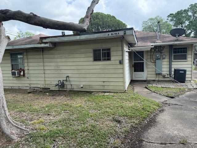 rear view of house with cooling unit