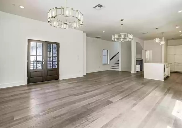 1217 Edwards St, Houston, TX 77007 - unfurnished living room featuring a chandelier, french doors, stairway, wood finished floors, and recessed lighting