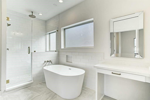 1217 Edwards St, Houston, TX 77007 - full bathroom with a stall shower, marble look tiles, tile walls, a freestanding bath, and healthy amount of natural light