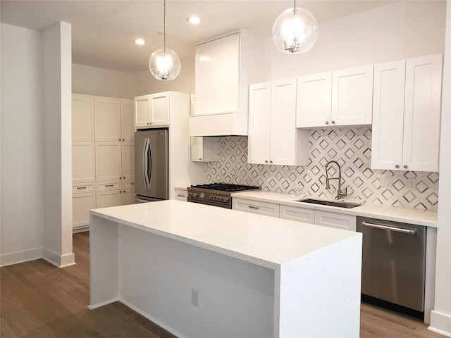 1217 Edwards St, Houston, TX 77007 - kitchen with appliances with stainless steel finishes, a sink, tasteful backsplash, wood finished floors, and recessed lighting