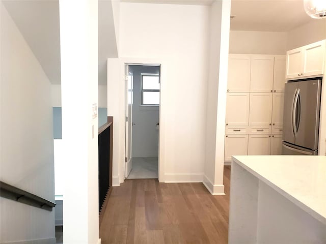 1217 Edwards St, Houston, TX 77007 - kitchen with freestanding refrigerator, light wood-style floors, white cabinetry, light countertops, and baseboards