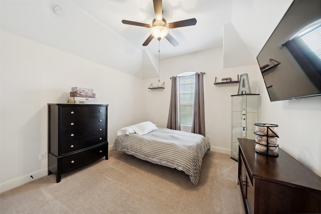 bedroom with light colored carpet, baseboards, and a ceiling fan