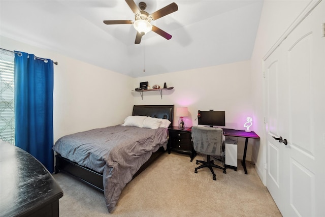 bedroom with light carpet, ceiling fan, and vaulted ceiling