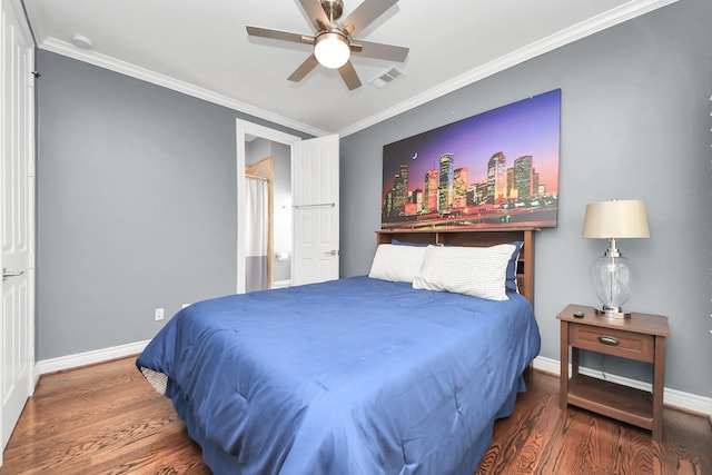 bedroom featuring visible vents, baseboards, crown molding, and wood finished floors