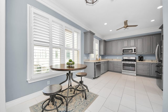 kitchen featuring a sink, appliances with stainless steel finishes, gray cabinetry, and a wealth of natural light