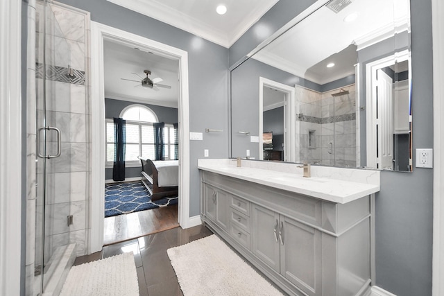 full bathroom with connected bathroom, crown molding, a shower stall, and a sink