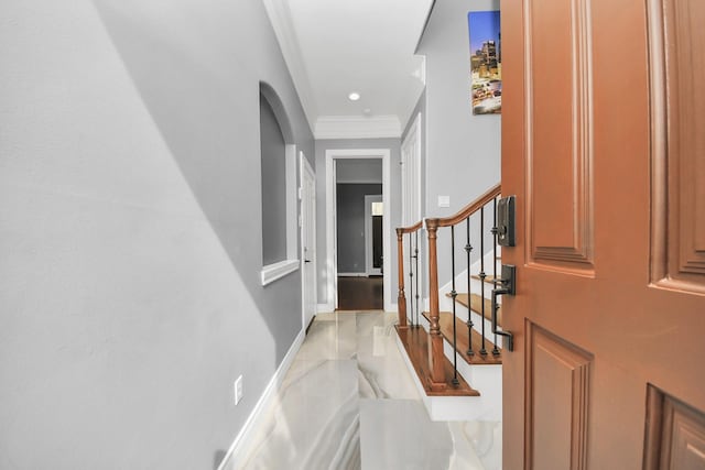 hallway with ornamental molding, stairs, and marble finish floor