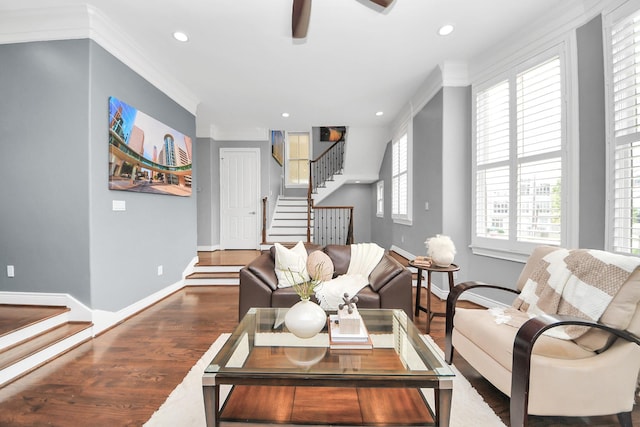 living room featuring ornamental molding, stairs, wood finished floors, baseboards, and recessed lighting