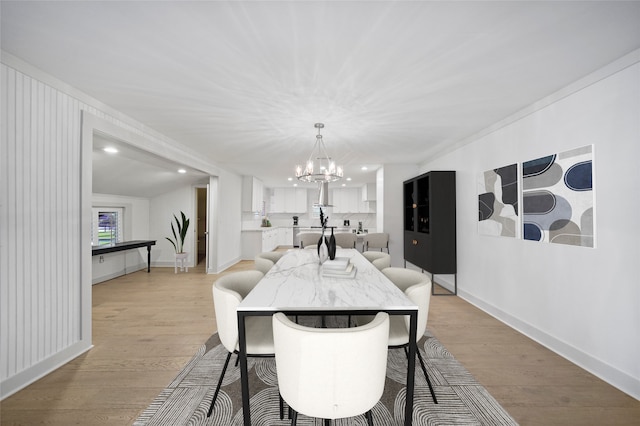 dining room featuring recessed lighting, baseboards, an inviting chandelier, and light wood-type flooring