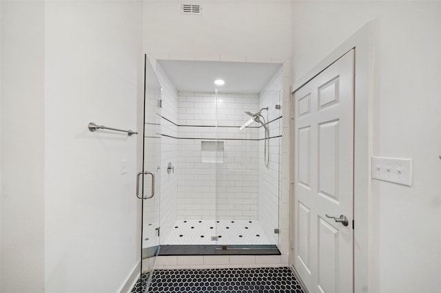 bathroom with tile patterned floors, visible vents, and a stall shower