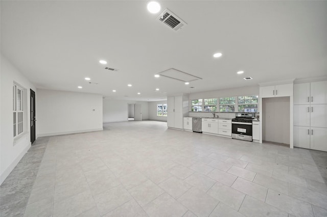 unfurnished living room featuring a sink, baseboards, visible vents, recessed lighting, and light tile patterned floors
