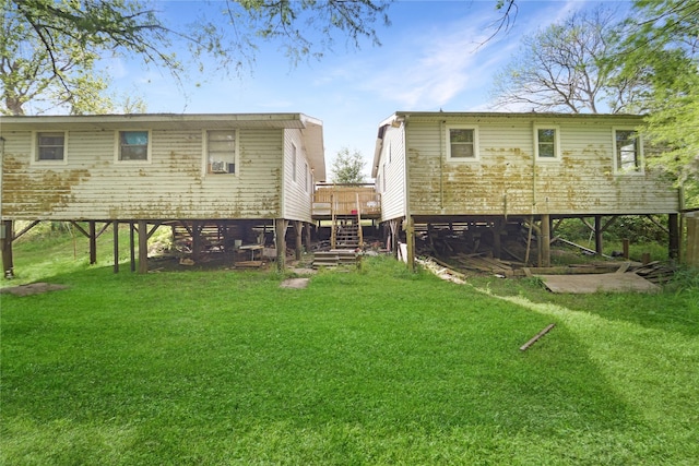 back of property featuring a lawn, stairway, and a deck