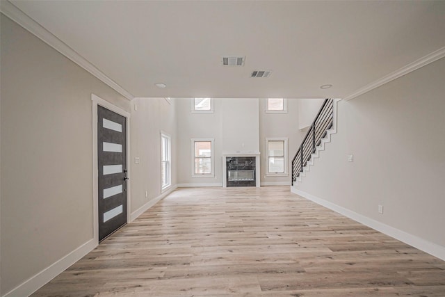 2102 Banks St, Houston, TX 77098 - unfurnished living room with visible vents, light wood finished floors, and ornamental molding