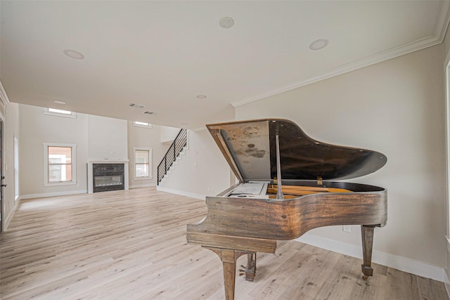 2102 Banks St, Houston, TX 77098 - living area with light wood finished floors, visible vents, ornamental molding, baseboards, and stairs