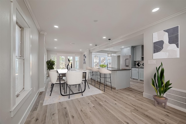 2102 Banks St, Houston, TX 77098 - dining room with crown molding, light wood-type flooring, french doors, baseboards, and recessed lighting