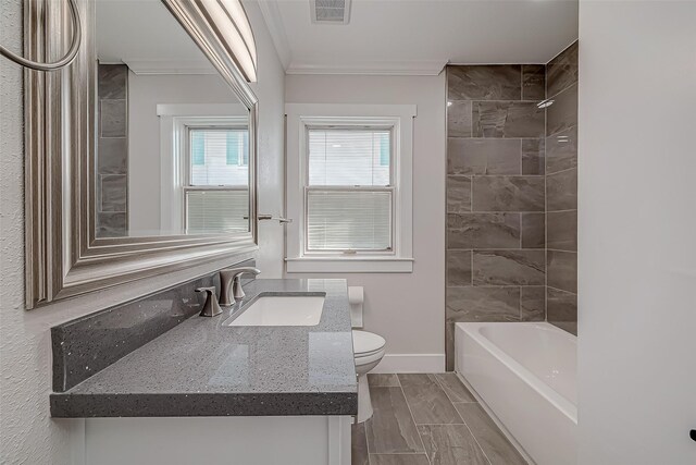 2102 Banks St, Houston, TX 77098 - full bathroom with washtub / shower combination, toilet, vanity, crown molding, and baseboards