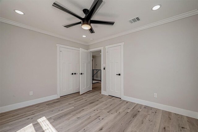 2102 Banks St, Houston, TX 77098 - unfurnished bedroom featuring crown molding, light wood-style floors, baseboards, visible vents, and recessed lighting