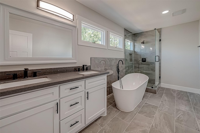 2102 Banks St, Houston, TX 77098 - full bathroom with double vanity, a sink, a freestanding bath, and a stall shower