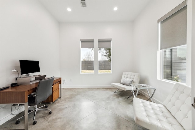 office area with concrete floors, visible vents, baseboards, and recessed lighting