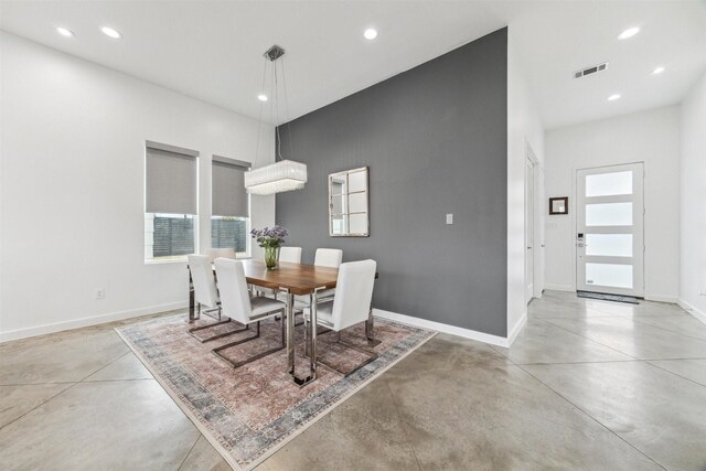 dining space featuring visible vents, concrete floors, and a healthy amount of sunlight