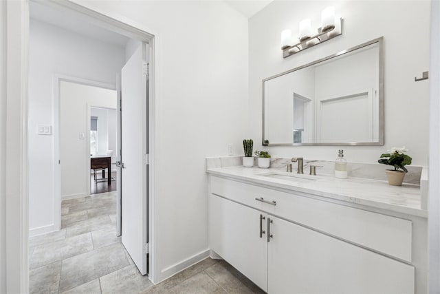 bathroom with baseboards and vanity