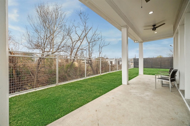 view of yard featuring a fenced backyard, a ceiling fan, and a patio