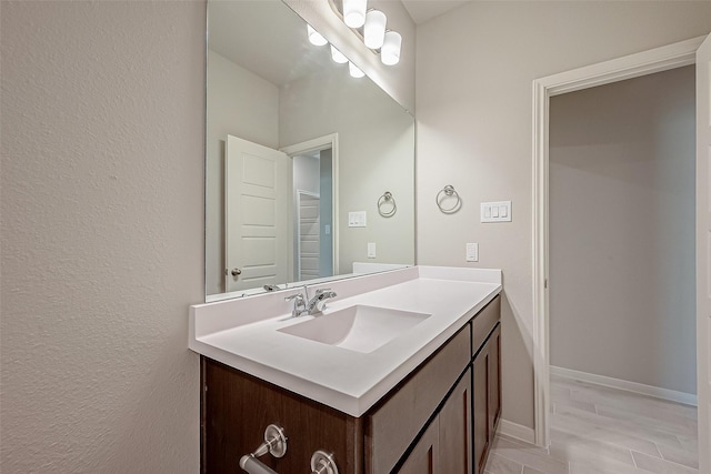 bathroom with baseboards and vanity