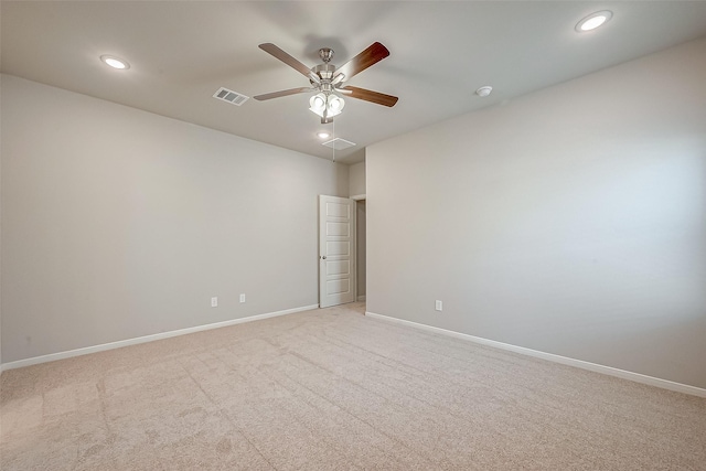 spare room featuring light carpet, a ceiling fan, visible vents, and recessed lighting