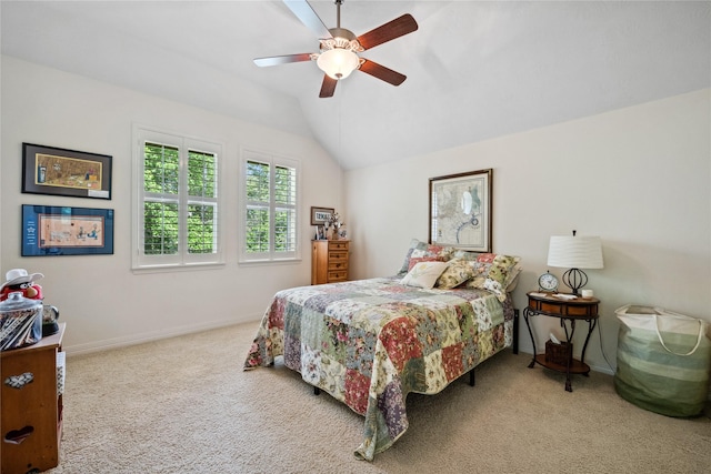 carpeted bedroom with vaulted ceiling, baseboards, and ceiling fan