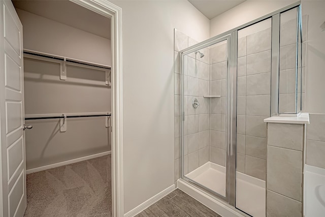 2128 Port Jackson, Texas City, TX 77568 - full bath featuring a walk in closet, a shower stall, and baseboards