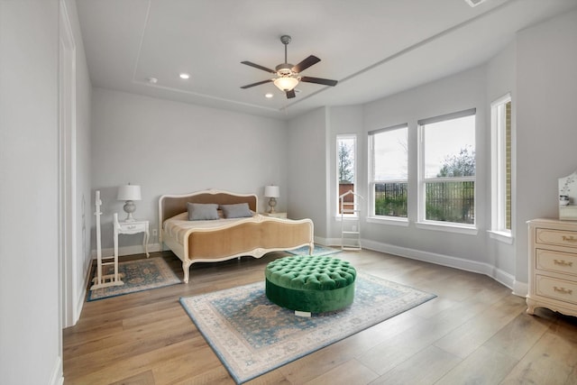 bedroom featuring light wood-type flooring, a ceiling fan, baseboards, and recessed lighting