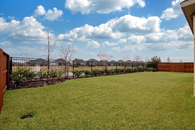 view of yard with fence and a residential view