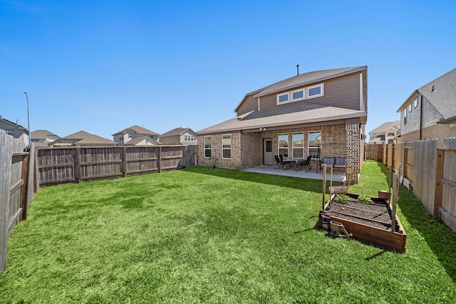 32610 Dew Crest St, Brookshire, TX 77423 - rear view of property with a fenced backyard, a garden, a patio area, a lawn, and brick siding