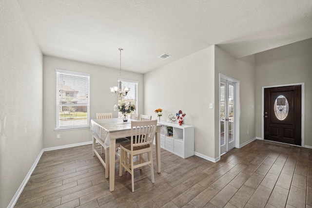 32610 Dew Crest St, Brookshire, TX 77423 - dining room with visible vents, baseboards, wood finished floors, and a notable chandelier
