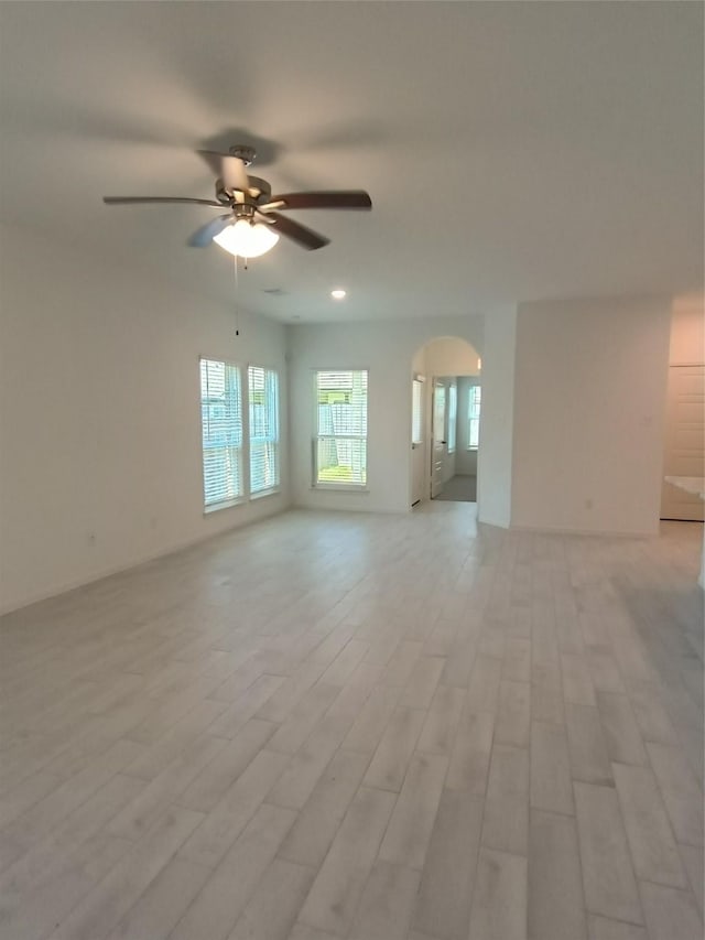 12367 Sterling Oak, Humble, TX 77044 - unfurnished room featuring ceiling fan, arched walkways, and light wood-style flooring