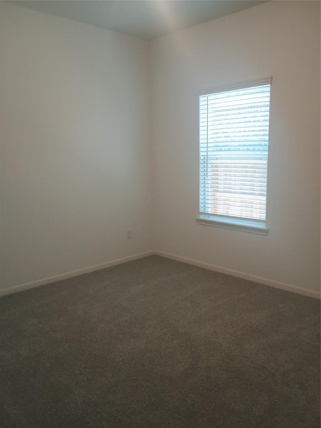 12367 Sterling Oak, Humble, TX 77044 - empty room with dark colored carpet and baseboards
