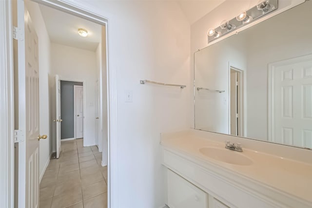 bathroom featuring vanity, baseboards, and tile patterned flooring