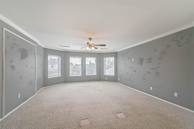 unfurnished room with ceiling fan, ornamental molding, visible vents, and carpet