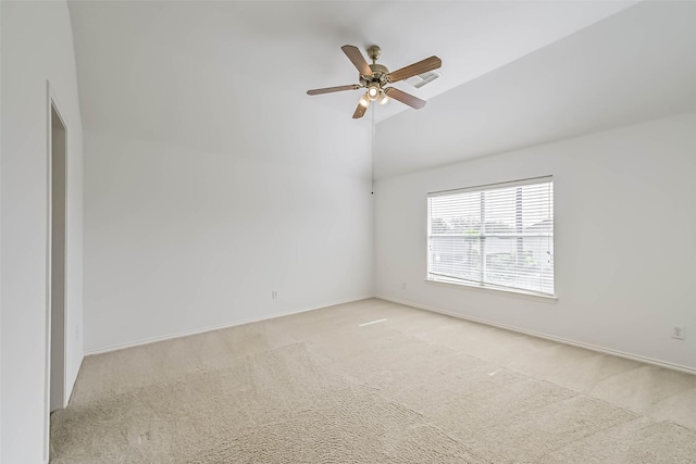 carpeted empty room with vaulted ceiling, visible vents, a ceiling fan, and baseboards
