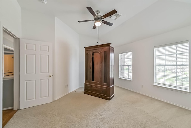 unfurnished bedroom featuring visible vents, baseboards, vaulted ceiling, and carpet flooring