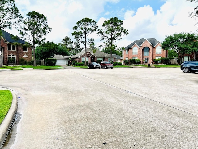 view of road with a residential view and curbs