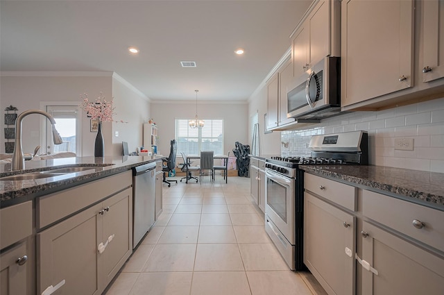 452 Long Beach Bay Dr, Katy, TX 77493 - kitchen featuring appliances with stainless steel finishes, a sink, crown molding, tasteful backsplash, and dark stone counters