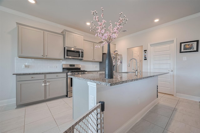 452 Long Beach Bay Dr, Katy, TX 77493 - kitchen with stainless steel appliances, a sink, gray cabinets, light tile patterned floors, and crown molding